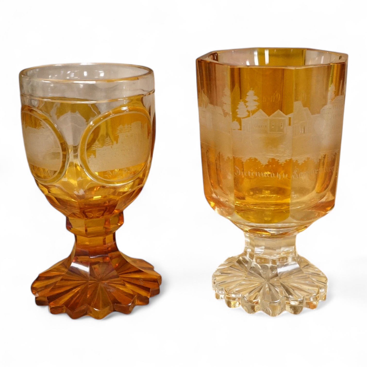 Two Bohemian topographical engraved amber flashed spa glasses, late 19th century, largest 13.5cm high